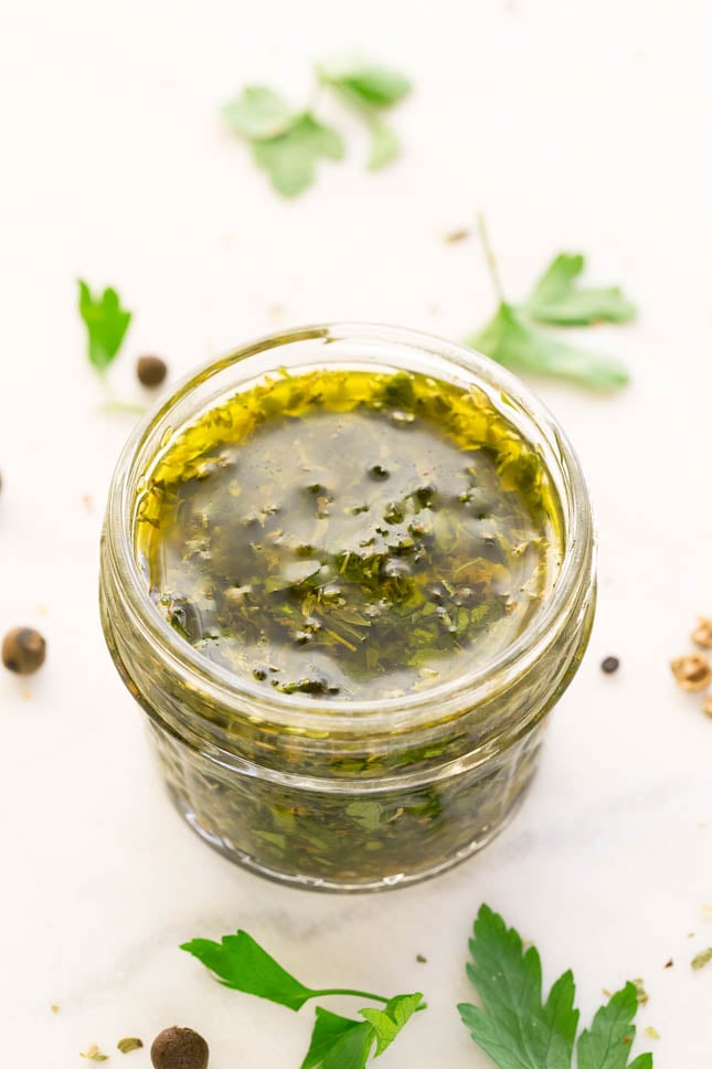 Photo of a little glass with chimichurri sauce in it