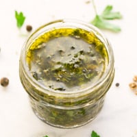 Square photo of chimichurri sauce in a little glass
