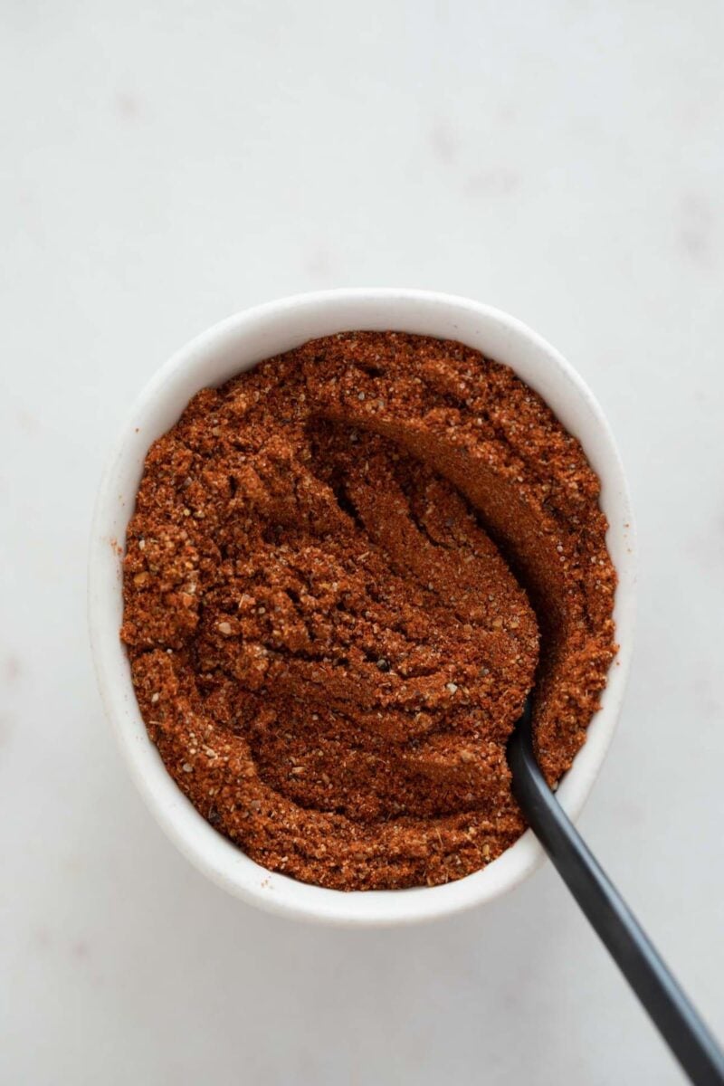 Overview photo of a small bowl with homemade Old Bay seasoning and a teaspoon.