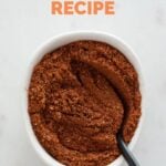 Overview photo of a small bowl with homemade Old Bay seasoning and a teaspoon with a heading.